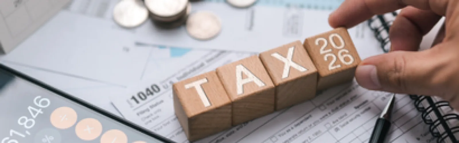 Tax Forms with Wood Blocks Spelling "TAX 2026"